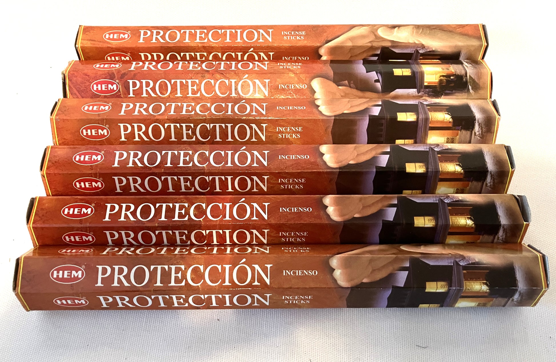 Stack of HEM 'Proteccion' incense sticks packaging on a white background