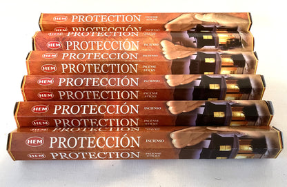 Stack of HEM 'Proteccion' incense sticks packaging on a white background