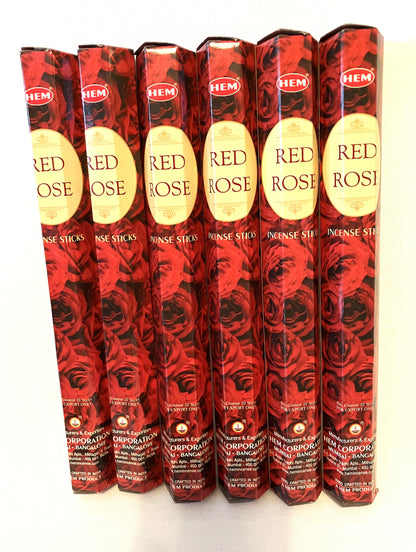 Multiple packages of HEM Red Rose incense sticks on a white background