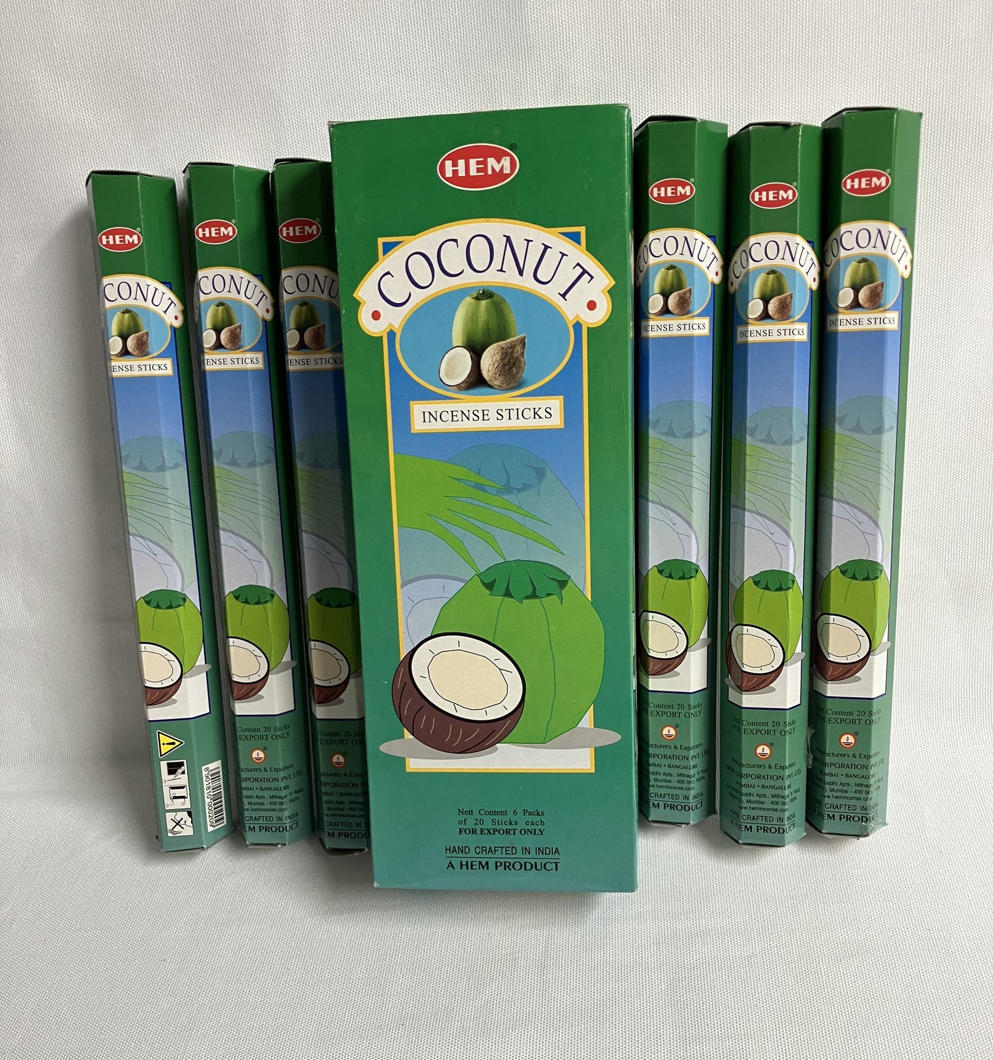 Multiple boxes of HEM Coconut Incense Sticks on a light gray background
