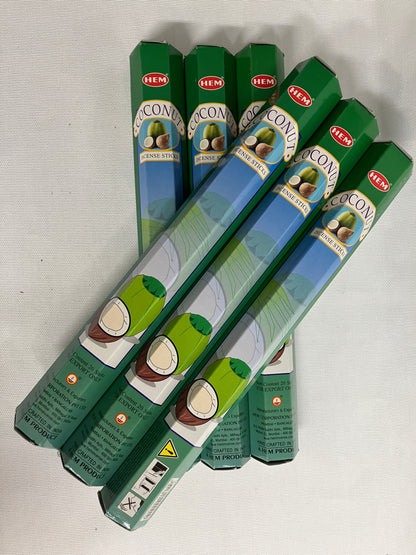 Stack of green HEMA coconut  incense packaging on a white background