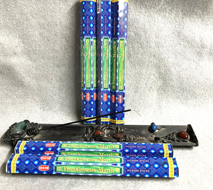 Hem Frankincense Myrrh Incense sticks with packaging and a decorative burner on a textured surface