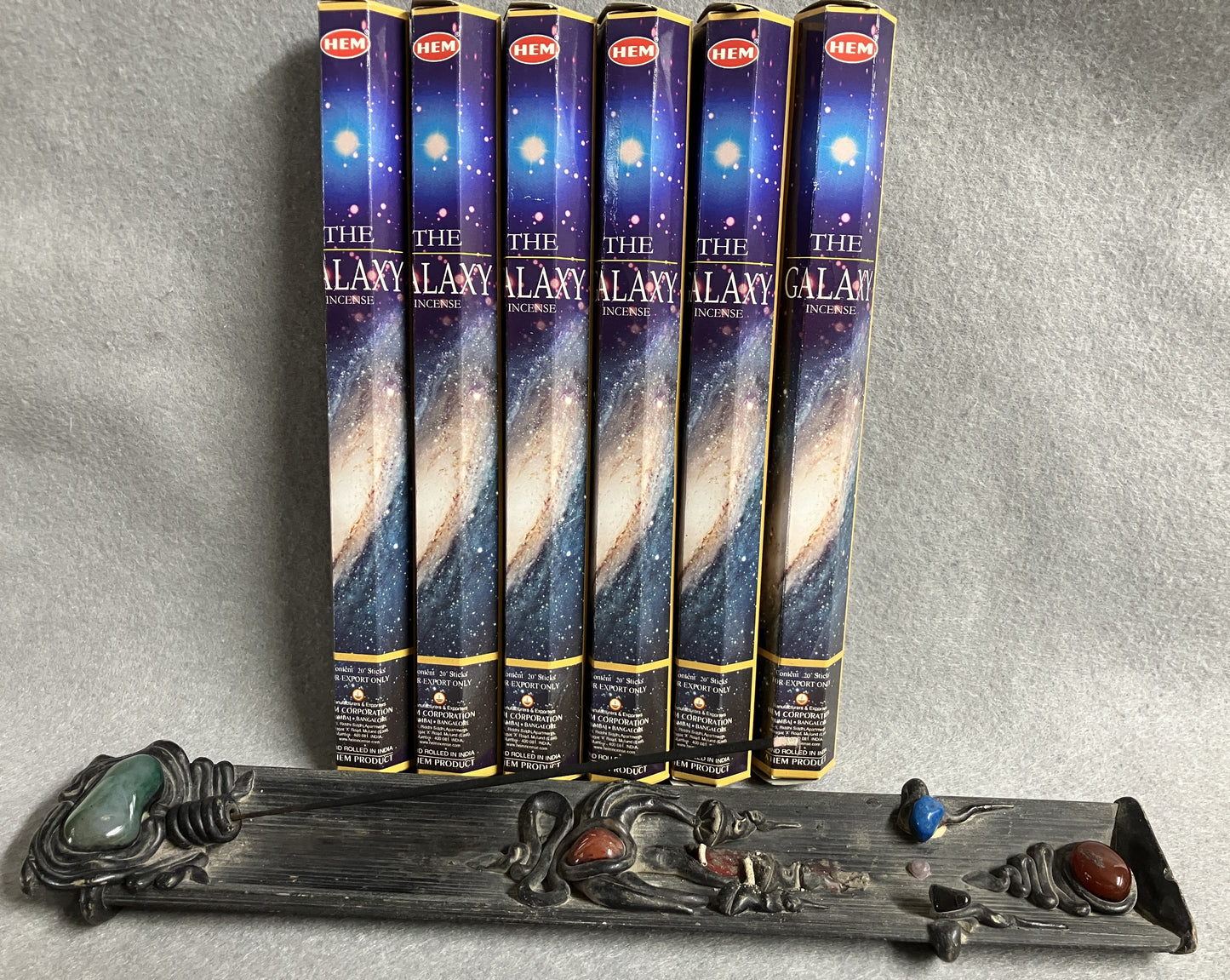 Set of 'The Galaxy' incense sticks with packaging shown with a decorative burner against a gray background