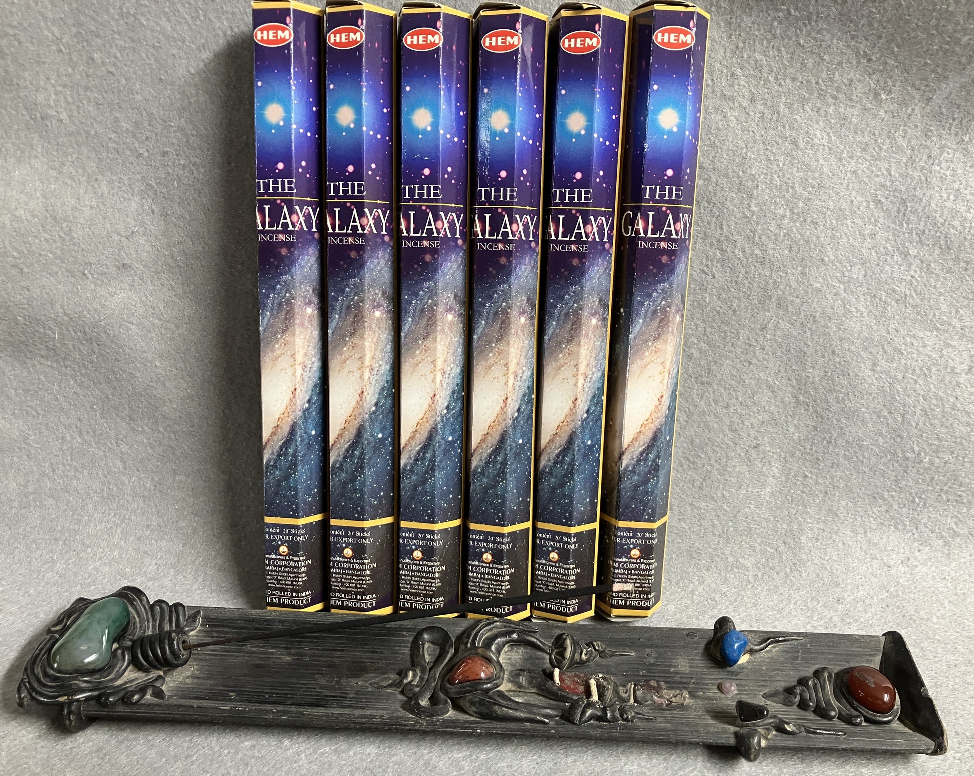 Set of 'The Galaxy' incense sticks with packaging shown with a decorative burner against a gray background