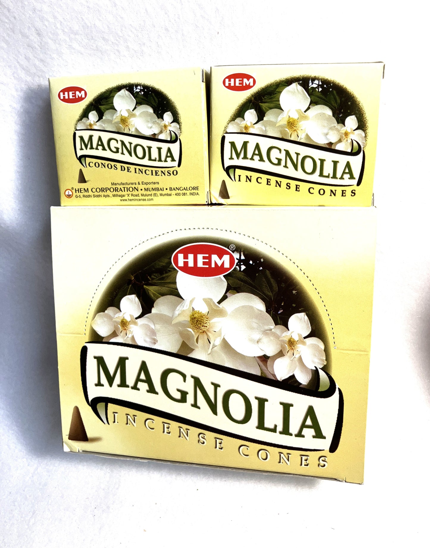 Master carton and two boxes of HEM Magnolia incense cones shown on a white background