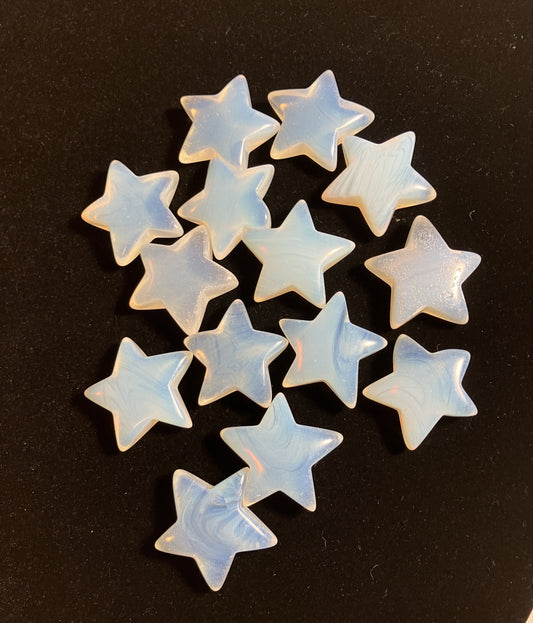 Opalite star-shaped crystals shown on  a black background