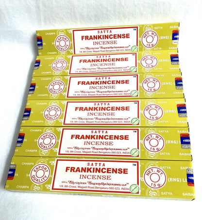 Multiple boxes of Satya Frankincense Incense stacked on a white background