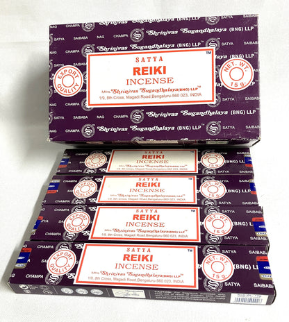 Multiple boxes of Satya Reiki Incense stacked on a white background
