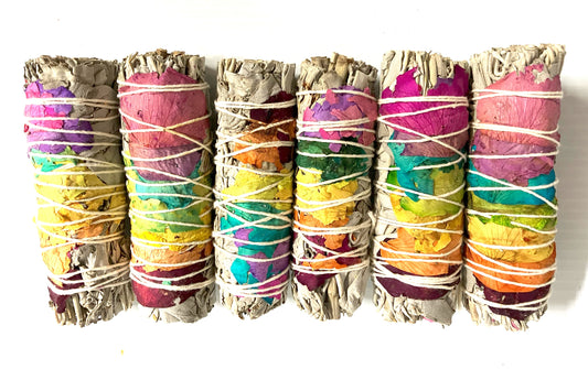 White Sage wrapped in Colorful Rose Pedals and white twine shown on a white background