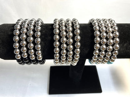 Natural stone bracelet showing bead detail and stainless steel accents