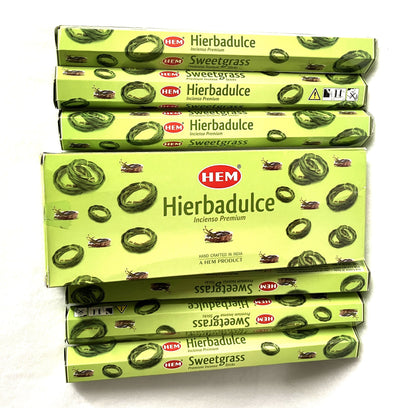 Stack of HEM Hierbadulice Sweetgrass incense boxes on a white background