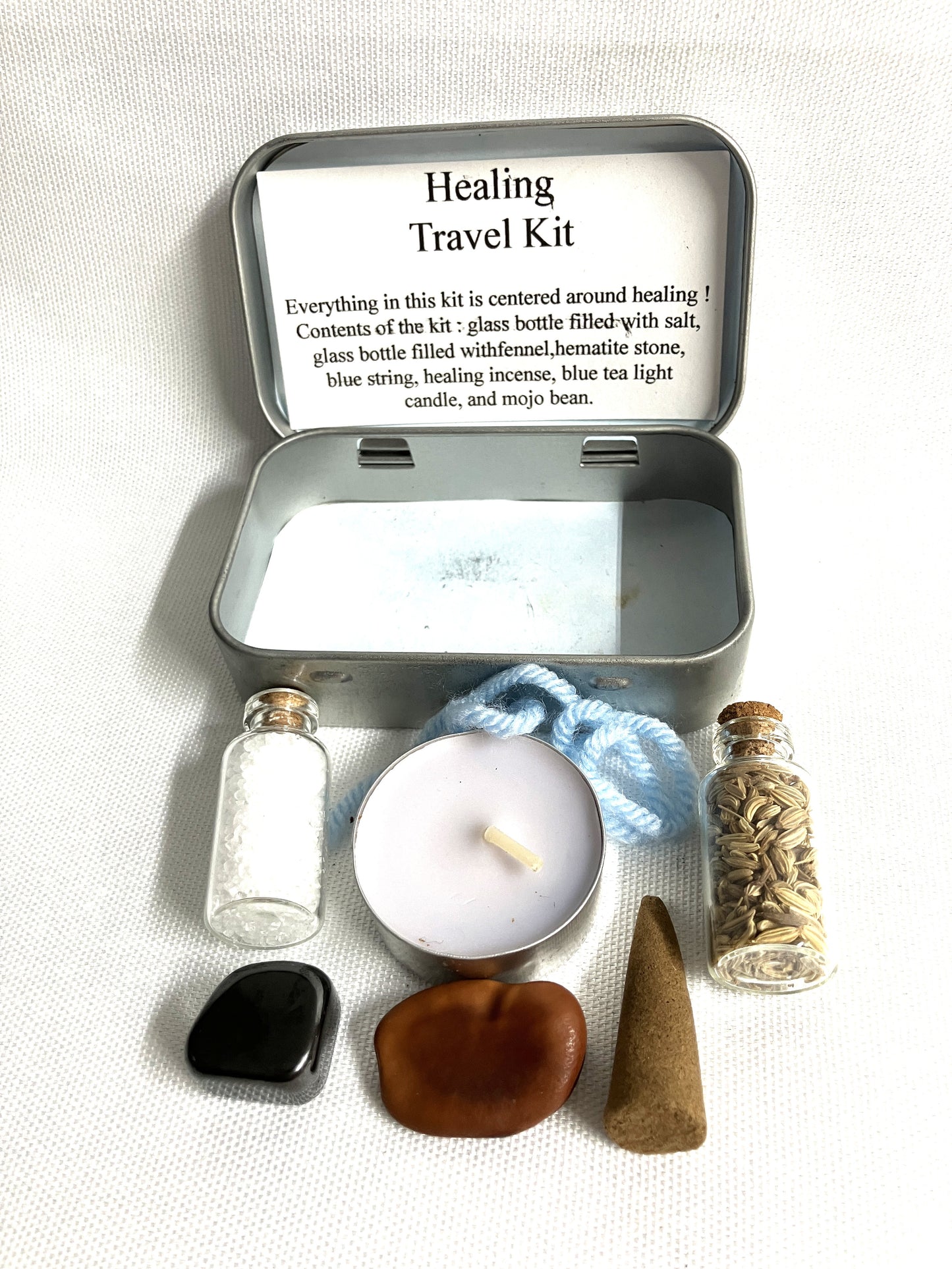 Healing travel kit with various items on a white background