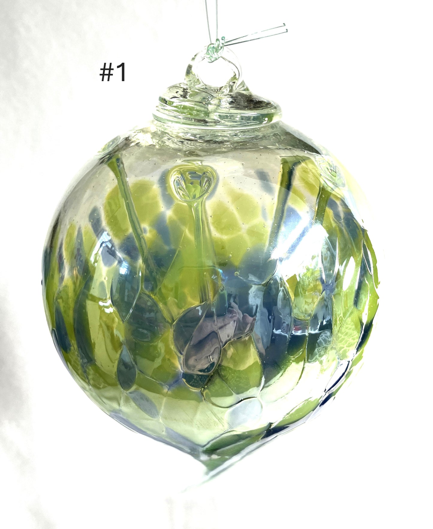 Blown Glass Witch Balls with green and blue patterns on a white background