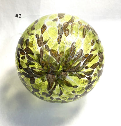 Blown Glass Witch Ball with floral pattern on a white background