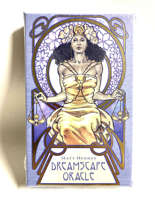 Packaging of 'Dreamscape Oracle' with a stylized illustration of a woman on a purple background.