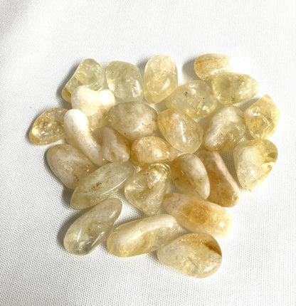 Bottom view of Citrine Tumbled Crystals on a white background