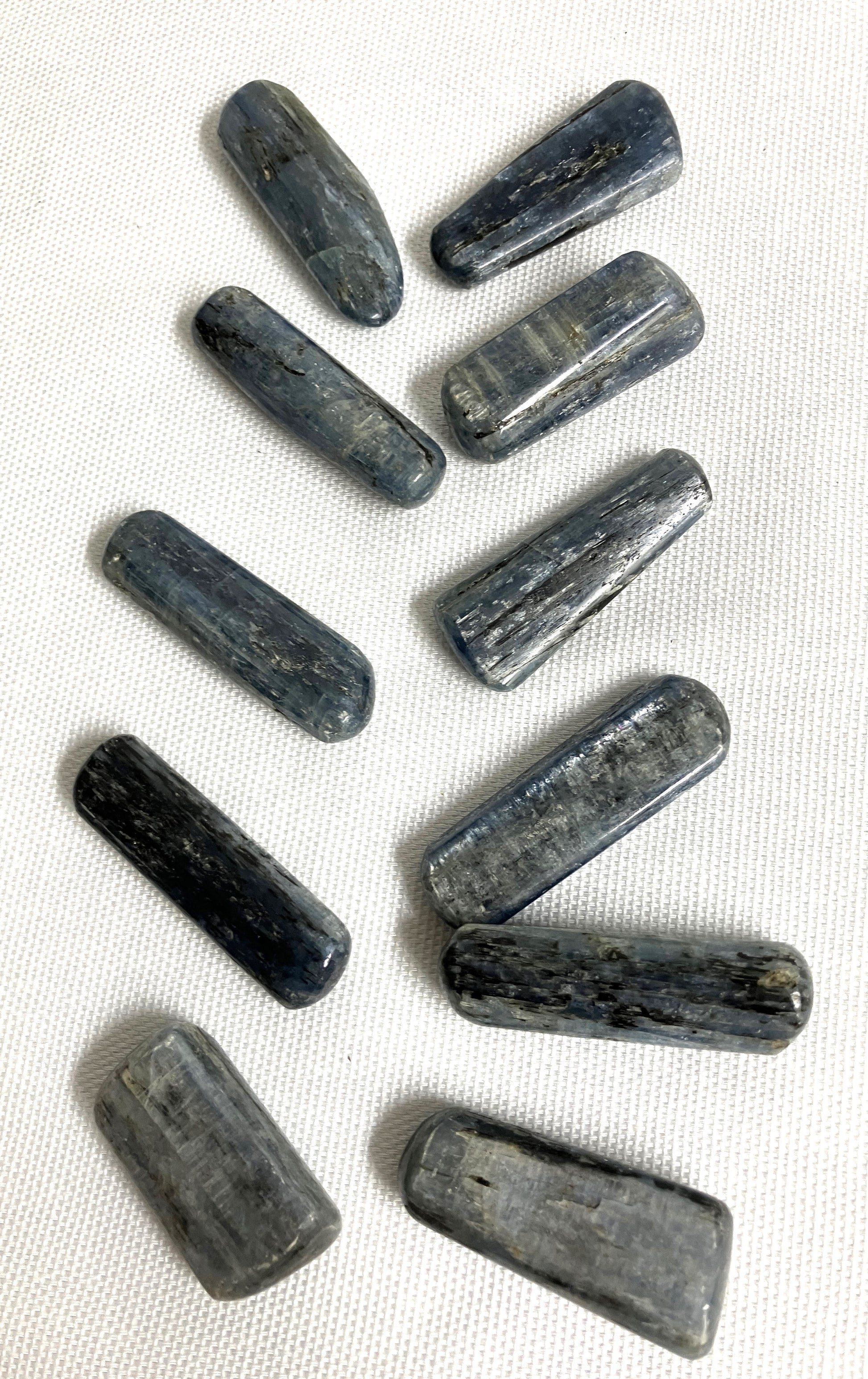 Blue Kyanite Crystals on a white fabric background