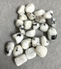 Front view of Rainbow Moonstone Crystals on a gray surface