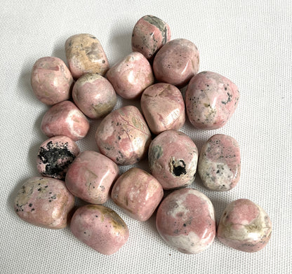 Group of Rhodochrosite Crystals on a white fabric background