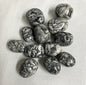 Collection of Pinolith Jasper Crystals on a textured beige surface