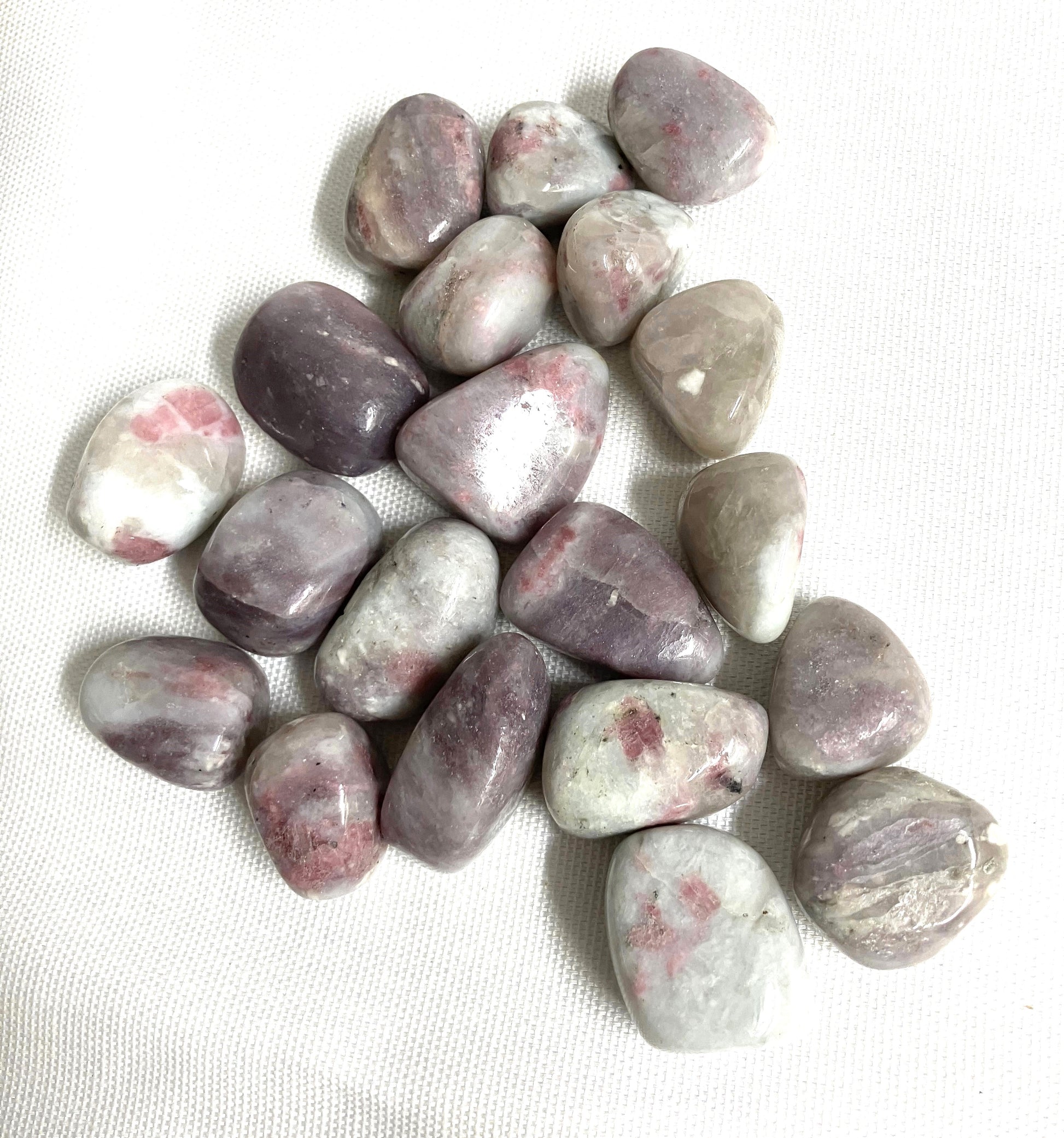 Pink Tourmaline Crystals showing the variations of color and pattern on a white background