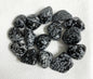 Snowflake Obsidian Crystals on a light fabric background