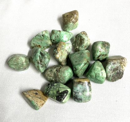 Tumbled Variscite Crystals on a white fabric background
