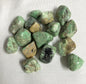 Collection of Variscite Crystals on a white fabric background front view