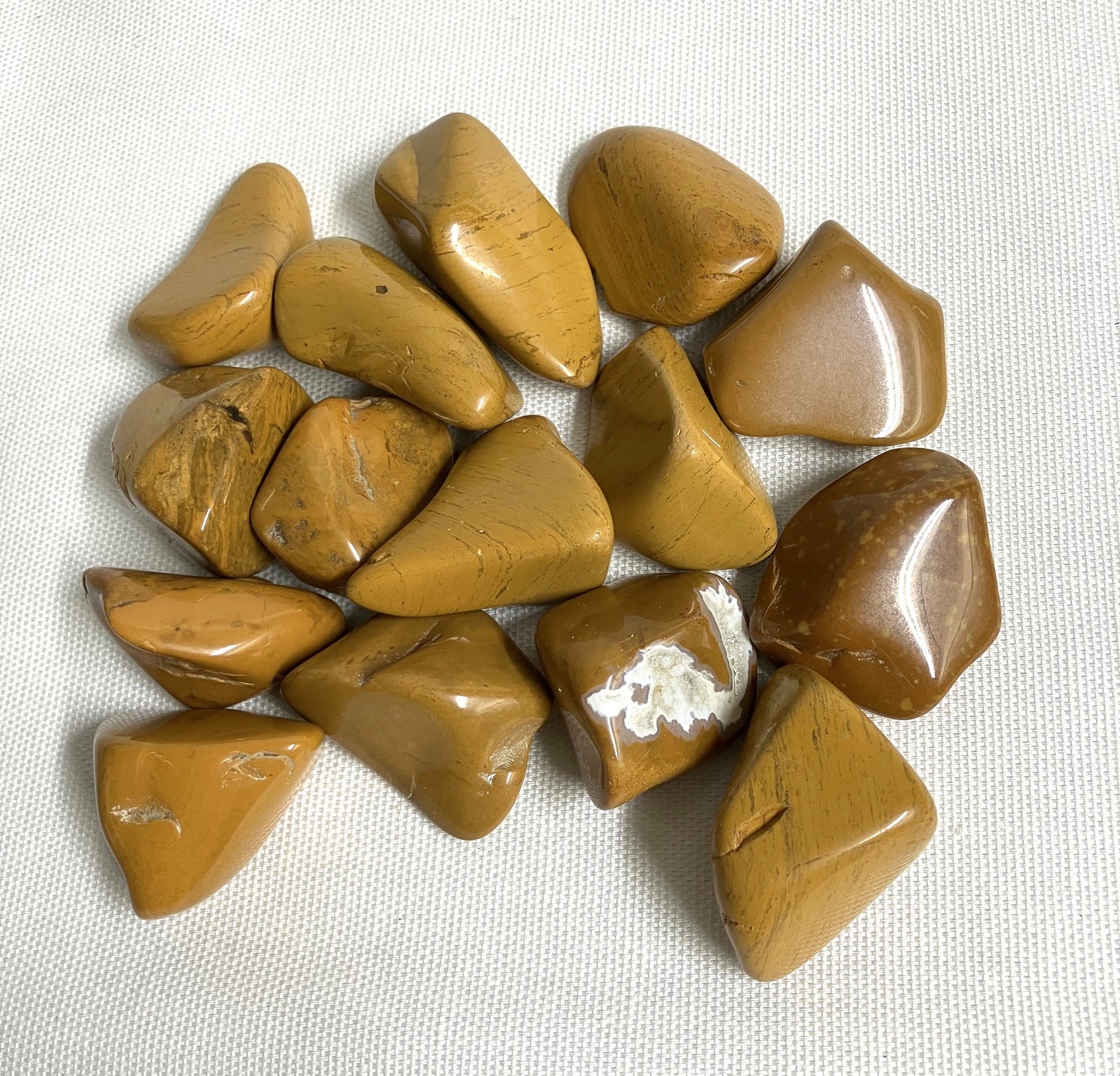 Group of Yellow Jasper Crystals on a textured white surface