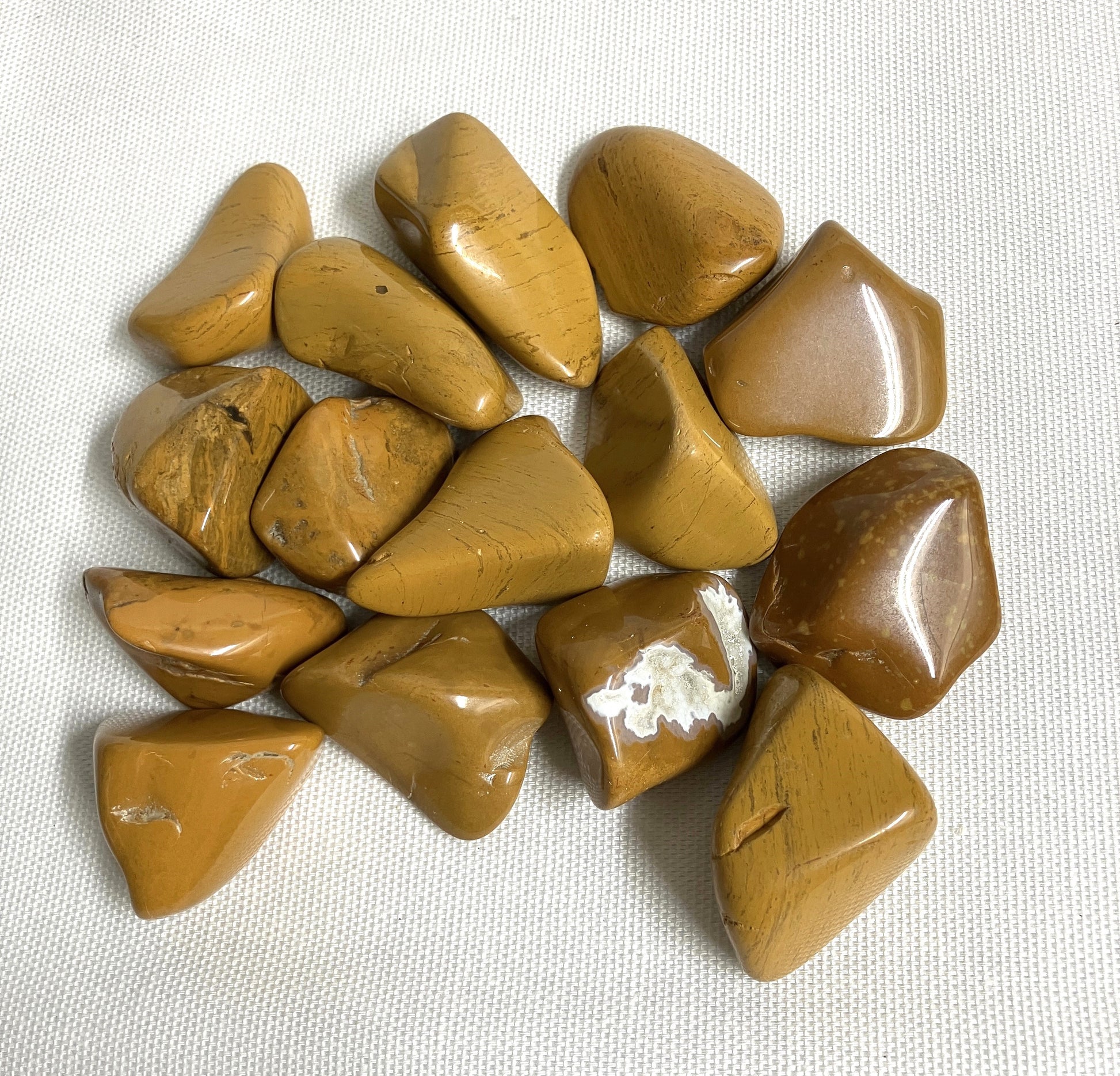 Group of Yellow Jasper Crystals on a textured white surface