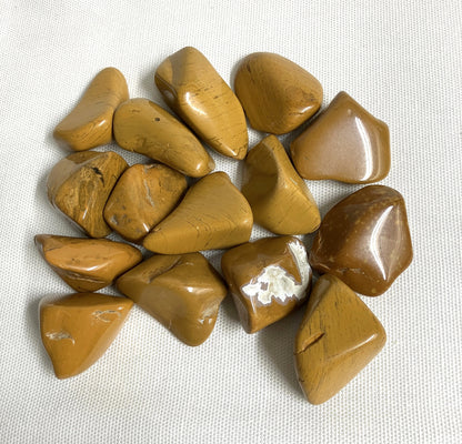 Group of Yellow Jasper Crystals on a textured white surface