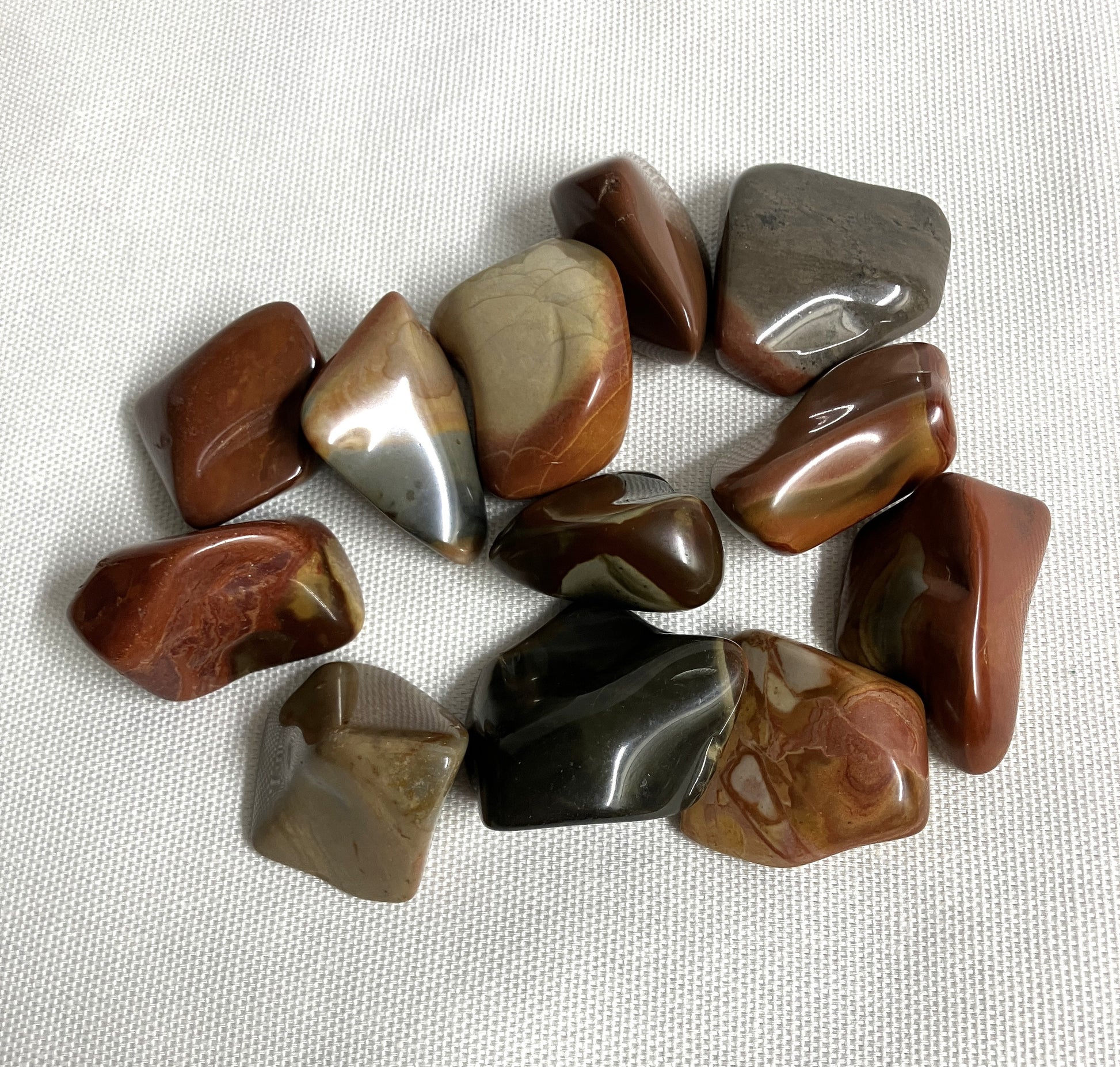 View 4 of Desert Jasper Crystal AKA Polychrome Jasper  on a textured white surface