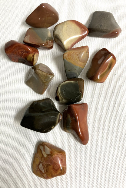 View 3 Desert Jasper Crystal AKA Polychrome Jasper  on a textured white surface