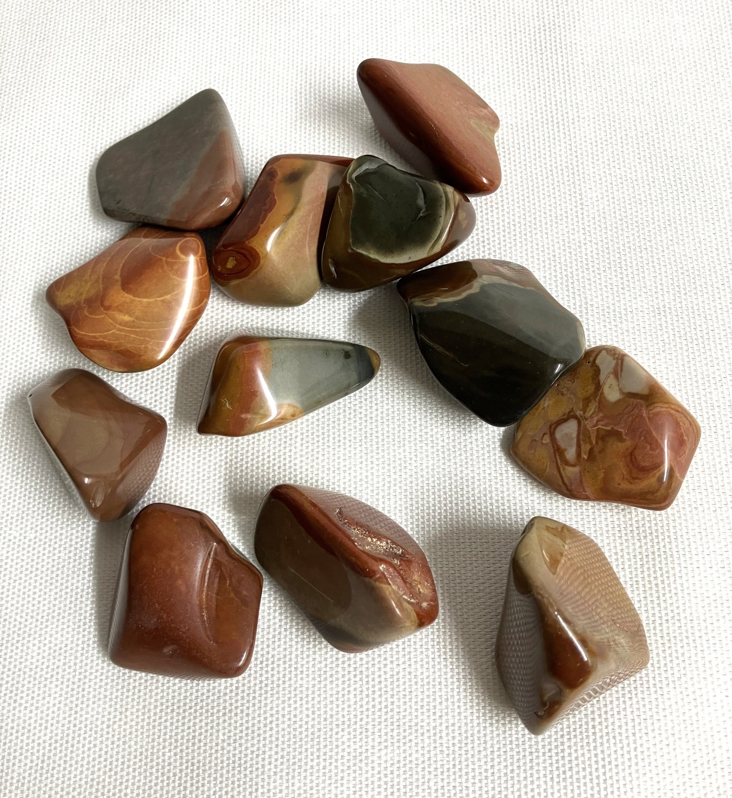 View 2 of Desert Jasper Crystal AKA Polychrome Jasper on a white fabric background