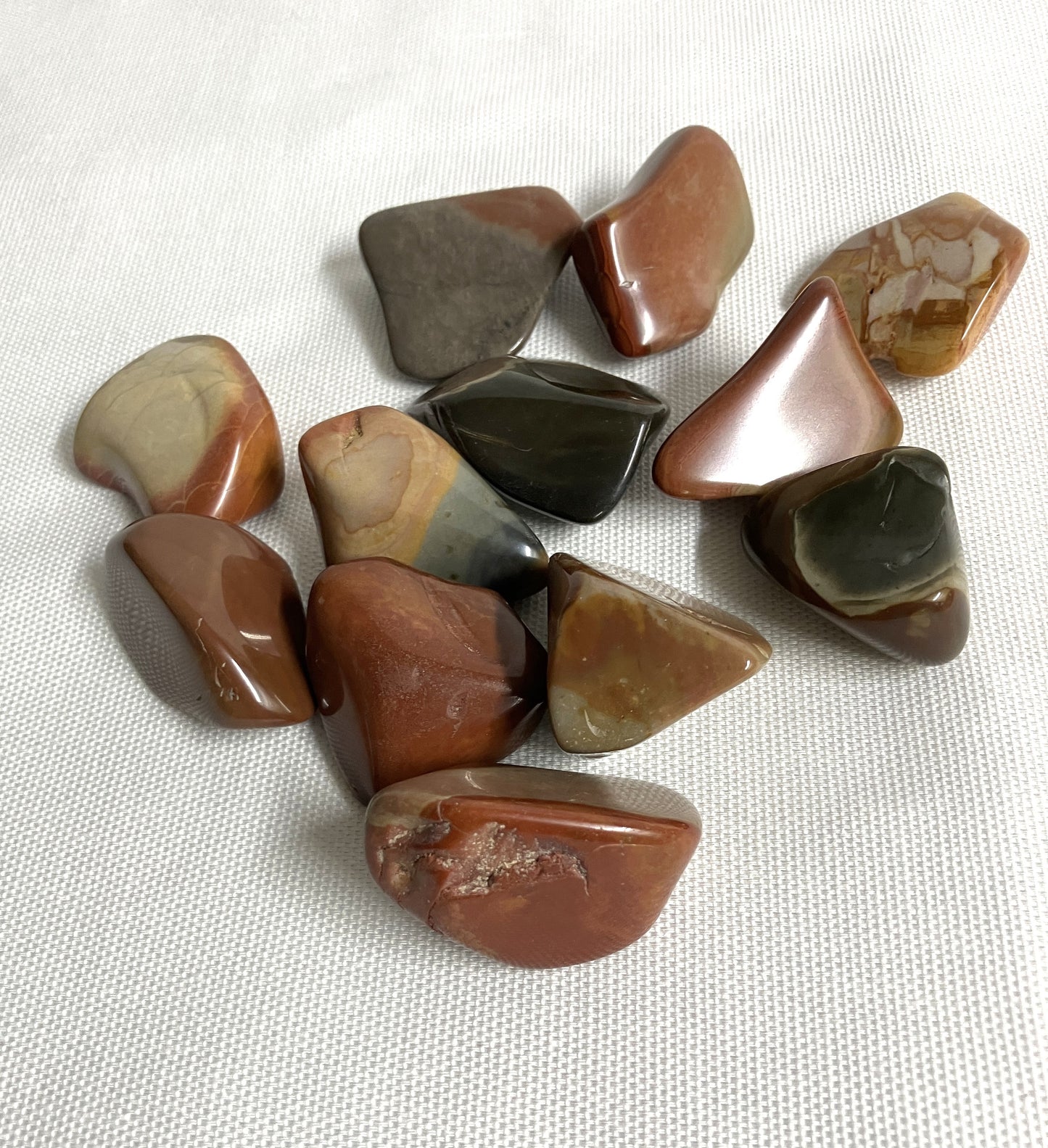 View one of Desert Jasper Crystal AKA Polychrome Jasper on a white fabric background