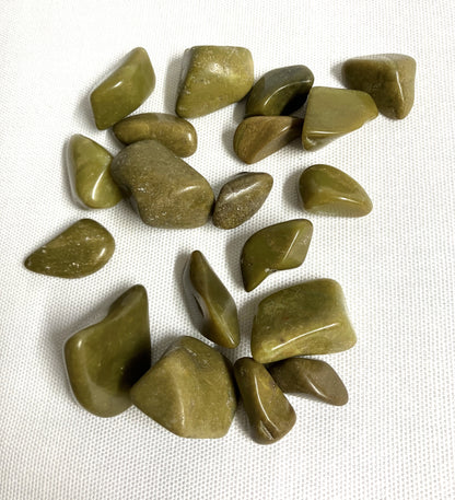 Top side of Green Opal Crystals on a white fabric background
