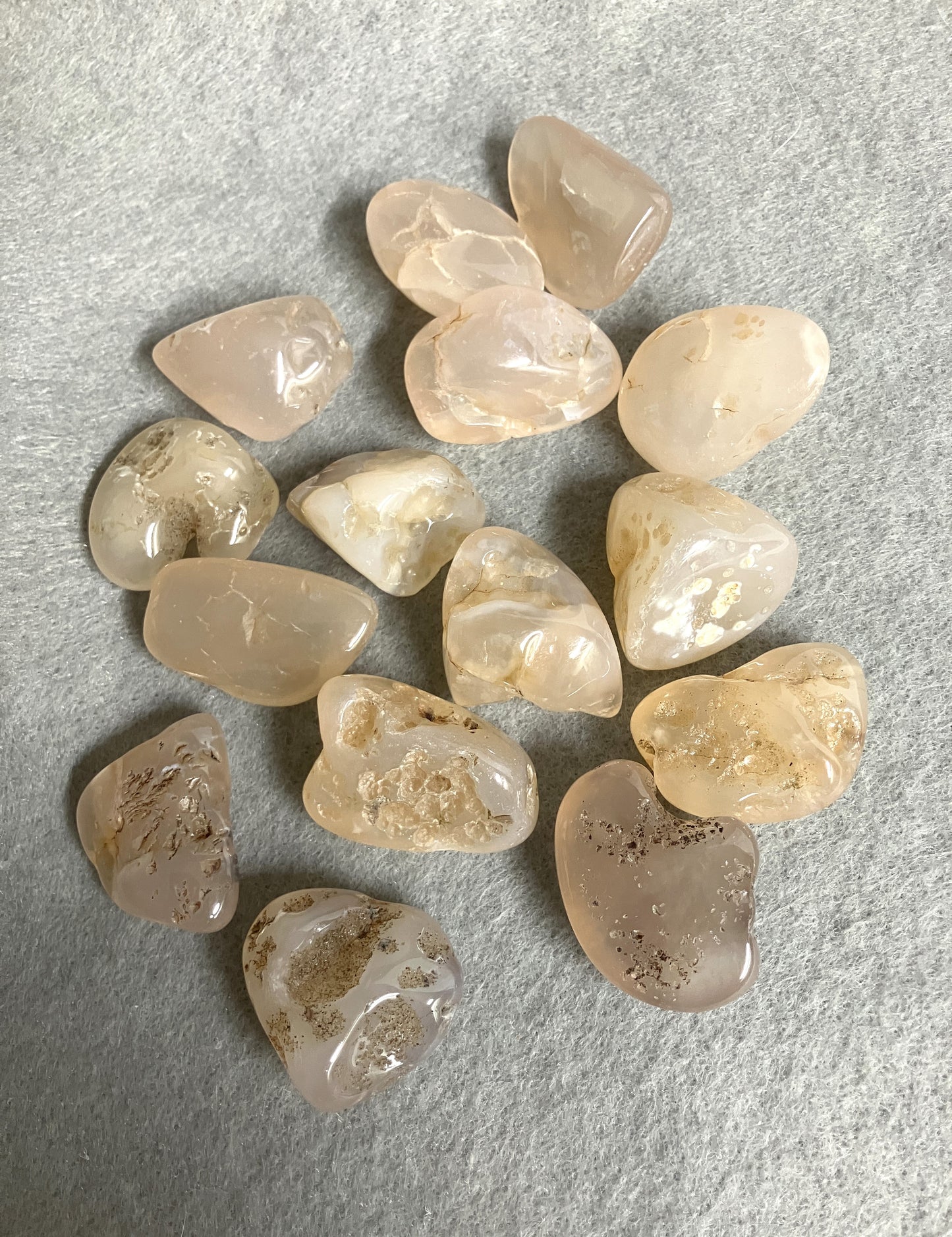Back view of Pink Chalcedony Crystals on a textured gray surface