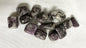 Closeup of Pink Garnet Tumbled Crystals on a textured white surface