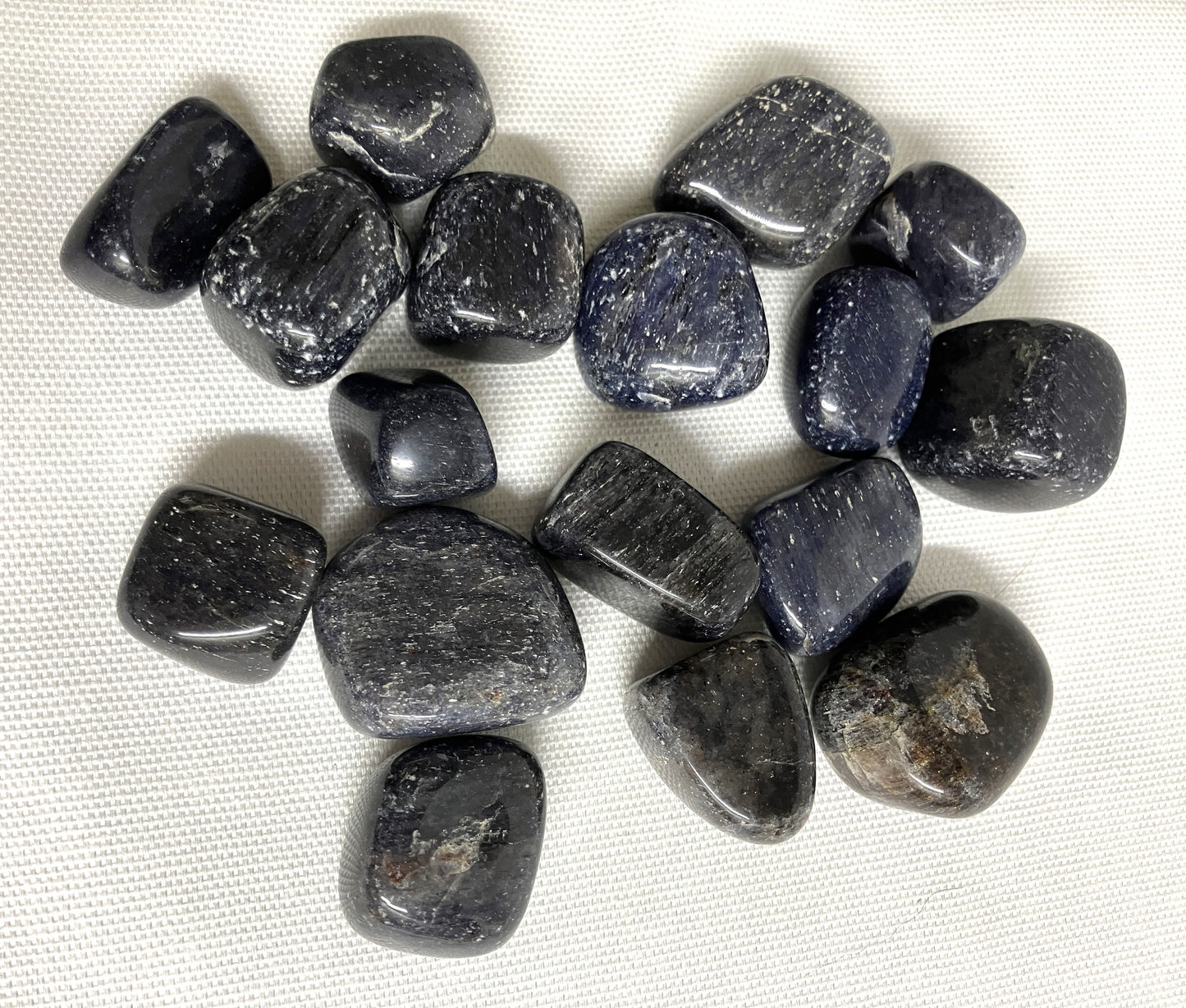 Bottom view of Blue Aventurine Tumbled Crystals on a white fabric background