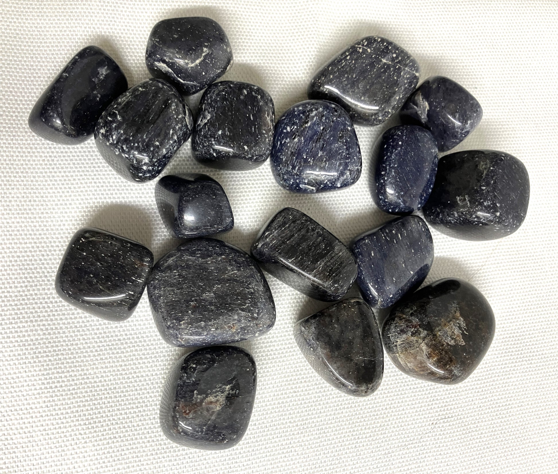 Bottom view of Blue Aventurine Tumbled Crystals on a white fabric background