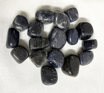 Top side of Blue Aventurine Tumbled Crystals on a white fabric background