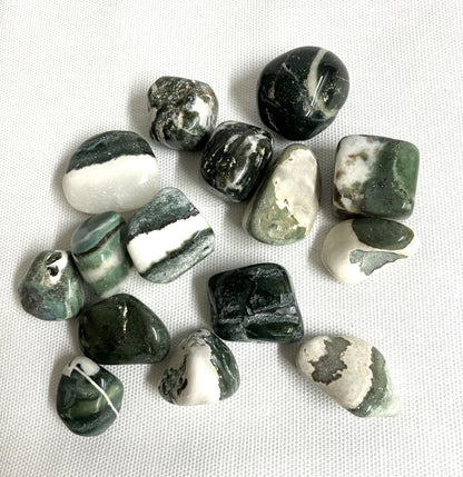 Collection of Green Sardonyx Crystals on a white fabric background