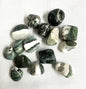 Collection of Green Sardonyx Crystals on a white fabric background
