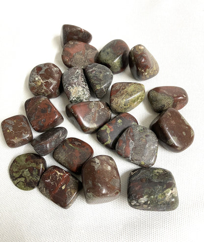 Collection of Dragons Blood Crystals showing the back side on a white fabric background
