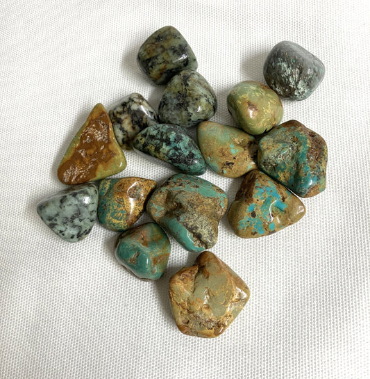 Front view of African Turquoise Crystals on a white fabric background
