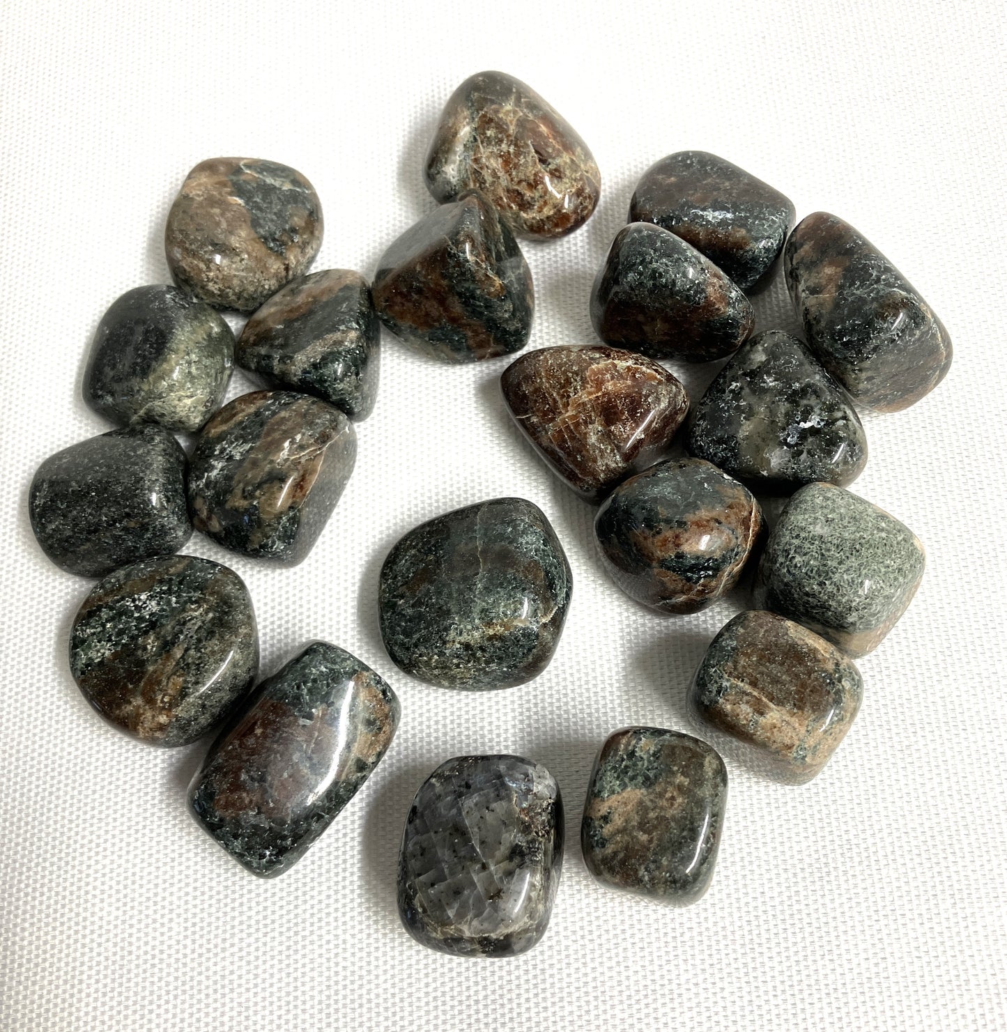 Group of Green Garnet Crystals on a white fabric background