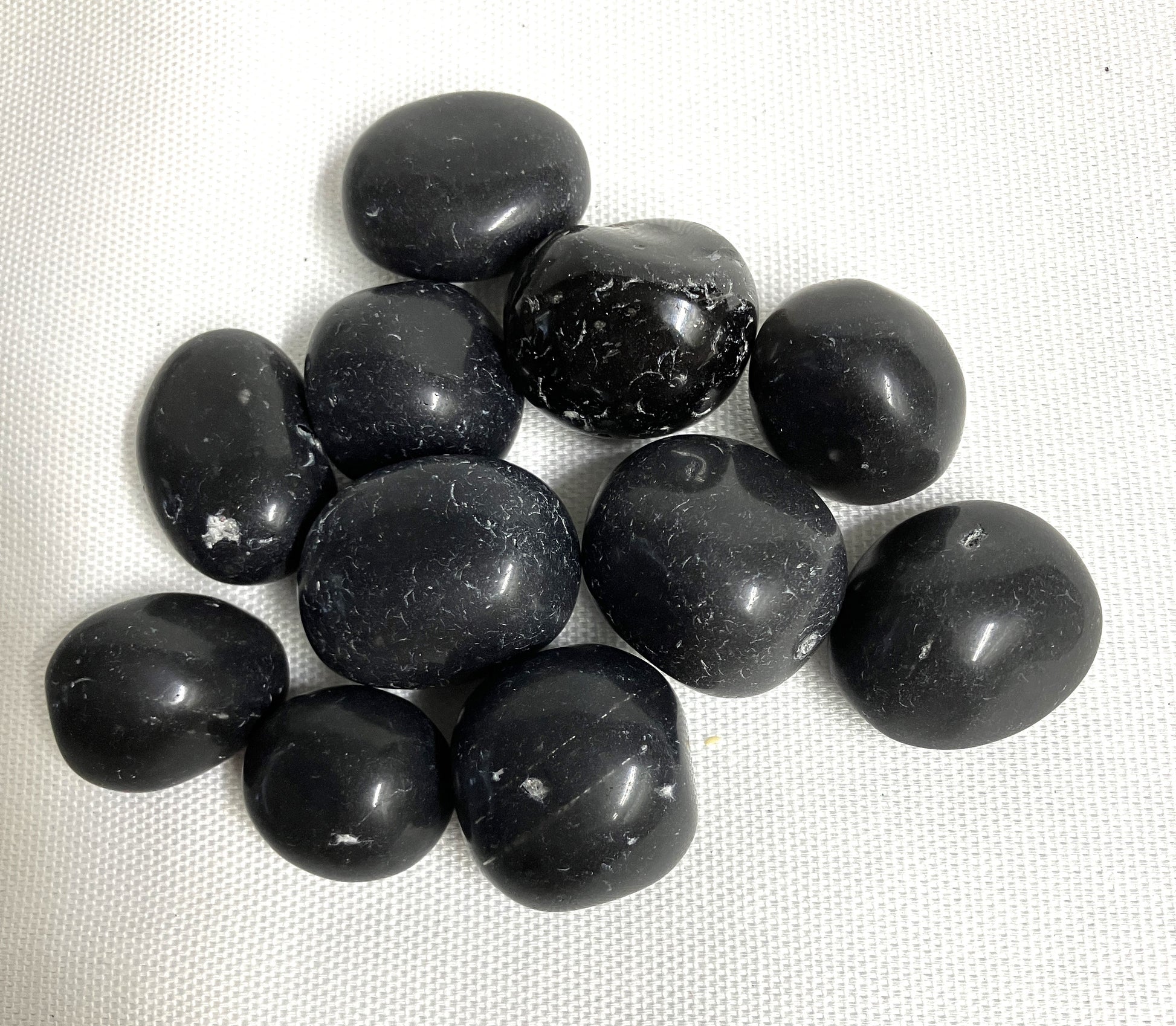 A closeup view of Black Agni Manitite Crystal aka Pearl of Fires showing details of the back. 