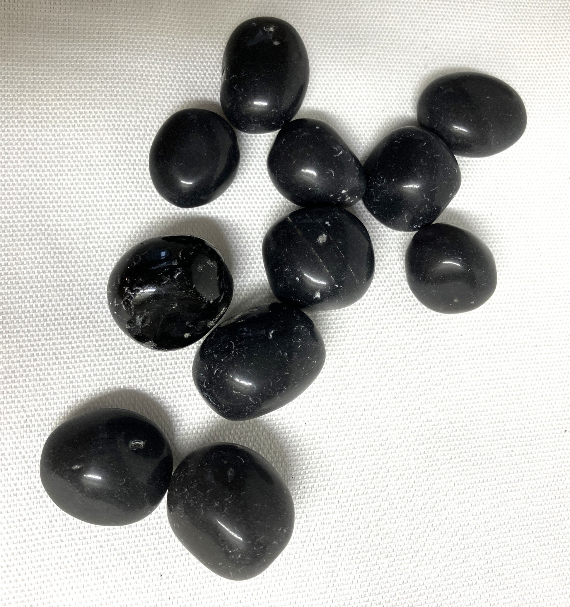 A group of assorted Black Agni Manitite Crystal aka Pearl of Fire showing a second side