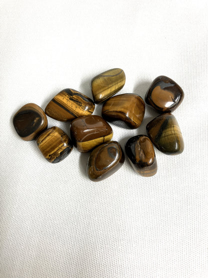 Back side of Yellow Tiger's Eye Crystals on a white fabric background