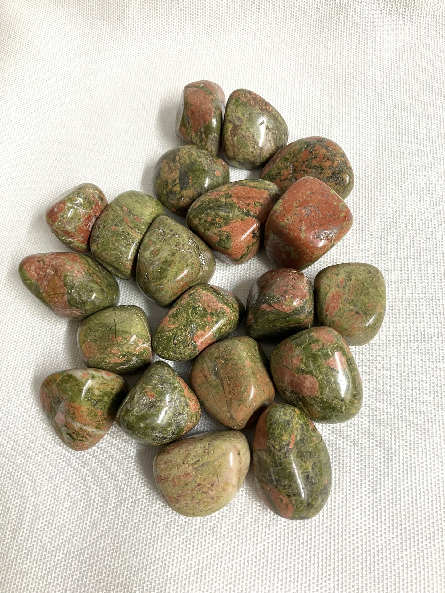 Group of Unakite Crystal  on a white fabric background